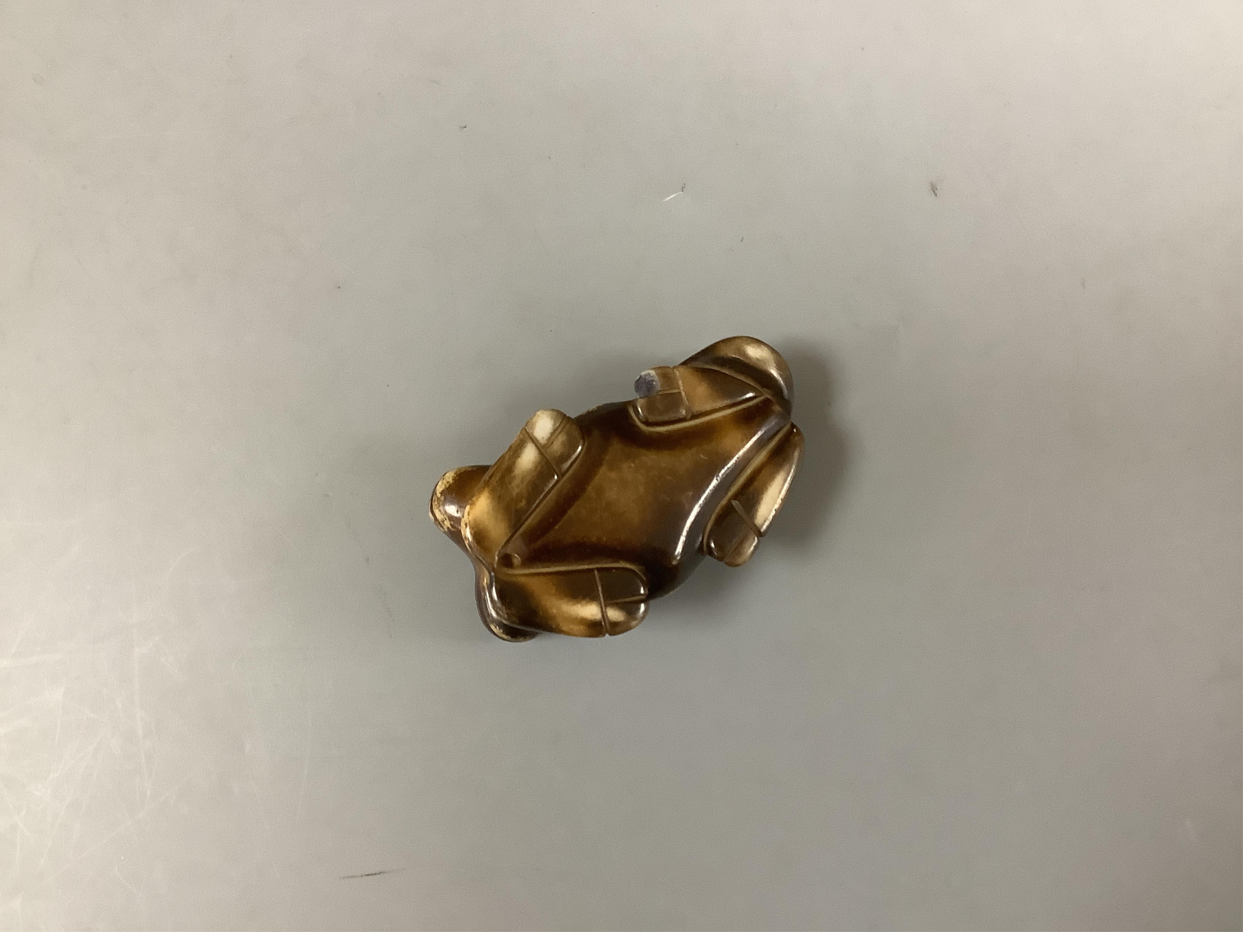 A Chinese pale green jade gourd pendant, a Chinese jade white and russet jade figure of a recumbent goat and a Chinese hardstone recumbent figure of an ox, largest 6cm wide (3)., Condition - good